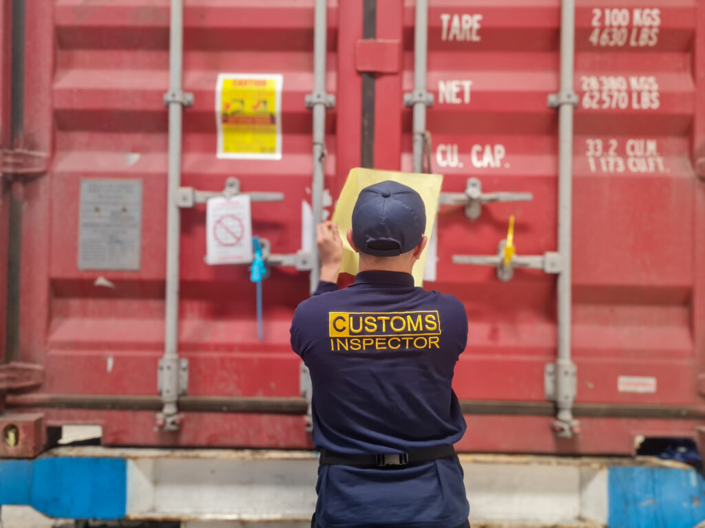 customs officers carry out inspections of cargo in export and import containers. investigations into trade and delivery of goods between countries in indonesia.